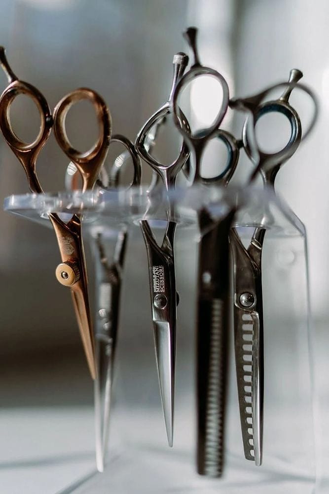Pairs of hair cutting scissors standing upright